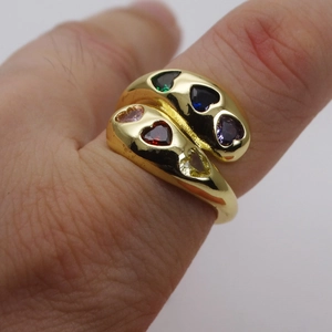 Macro view of wide 14k gold plated wrap ring with colorful heart-shaped cubic zirconia