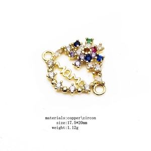 Macro view of MAMA letter connector with multicolor zircon stones and copper link loops