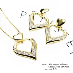 Close-up of 14K gold plated heart necklace and earrings set with sparkling zircon stones