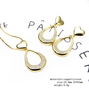 Detail view of heart shaped jewelry set with gold copper and sparkling zircons