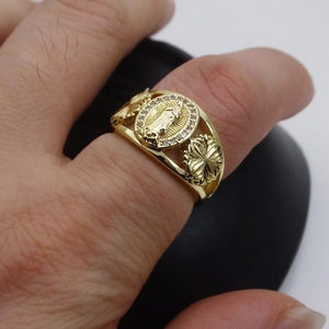 Close-up of 14k gold plated Virgin Mary heart ring with pavé zircon and flower relief