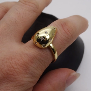 Detail of 14k gold plated ring with micro-set zircon and 3D oval center design