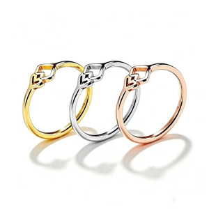 Detailansicht von drei geometrischen Titanstahlringen in Gold, Silber und Roségold.