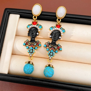 Close-up view of vintage resin portrait earrings featuring colorful rhinestones and beads