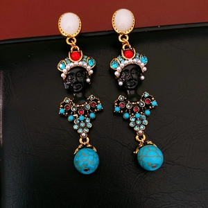 Detailed close-up of vintage resin portrait earrings with vibrant rhinestone embellishments