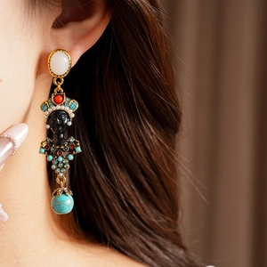 Vintage style drop earrings with resin portrait and turquoise stone on ear