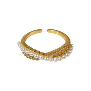 Elegant gold open ring with crisscross design featuring small pearls and zircons