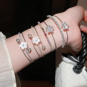 Elegant double-layer open bracelet with zircon and mother-of-pearl flowers on wrist