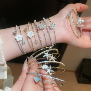 Detailed view of elegant double-layer bangles featuring zircon flowers and star charms