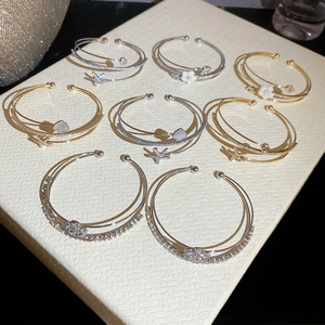 Detailed view of elegant double-layer zircon and mother-of-pearl flower open bangles