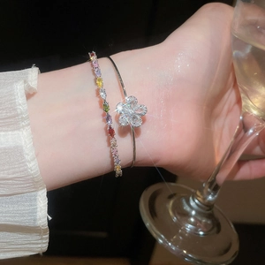 Close-up of elegant double-layer bracelet with zircon flower and colorful stones