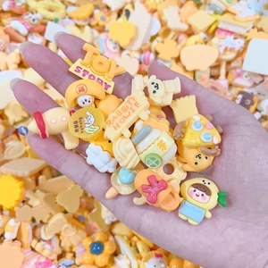 DIY cream glue kit with mixed yellow cartoon resin charms like bears and tea cups