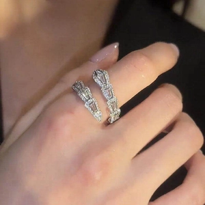 Close-up detail of an elegant silver snake-shaped open ring with sparkling cubic zirconia.