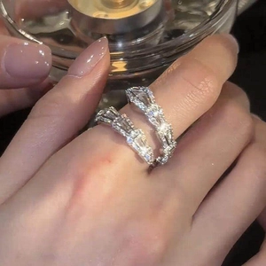 Close-up of exquisite silver-tone snake ring with shimmering zircon stones on finger