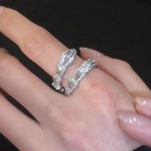 Detailed close-up of a sparkling zircon-encrusted silver snake ring worn on a finger.