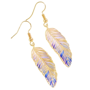Macro view of gold feather earrings featuring vibrant blue and pink gradient texture