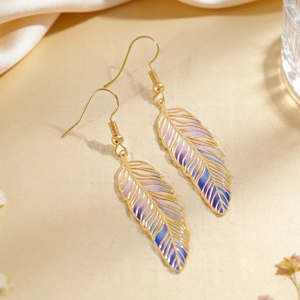 Macro detail of vintage feather earrings with purple and blue gradient enamel finish