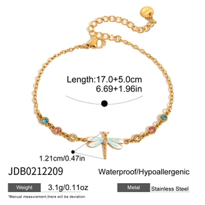 Close-up detail of gold dragonfly bracelet featuring zircons and technical specifications