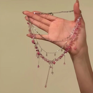 Detailed close-up of sweet ethereal pink and white beaded multi-layered choker necklace