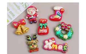Macro detail of mixed holographic resin Christmas charms including Santa and reindeer
