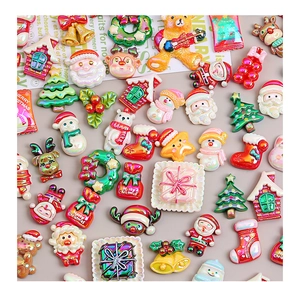 Macro view of pearlescent Christmas resin charms including Santa, snowmen and reindeer