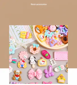 Flat lay macro of colorful resin charms featuring cartoon characters and floral shapes for DIY