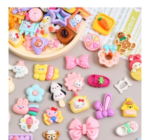 Flat lay of colorful cartoon resin charms for DIY cream glue accessories and crafts