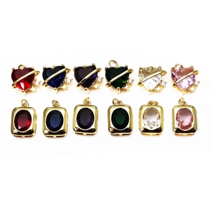 Colorful heart and rectangle crystal charms with gold edges and star details on white background