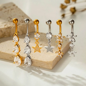 Stainless steel belly button rings with star and teardrop charms in gold and silver