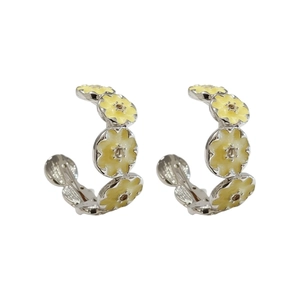 Floral C-shaped silver earrings featuring yellow enamel petals and zircon stones