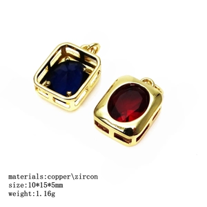 Detail of copper zircon pendants in blue and ruby red with gold-plated frames