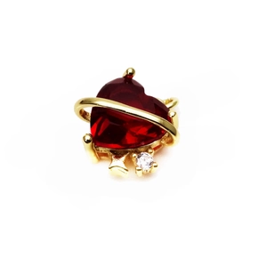 Detail of heart-shaped ruby-red crystal pendant with gold ring and white zircon stone