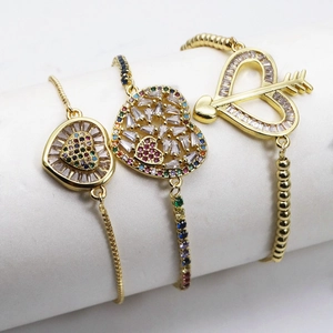 Detailed shot of gold-plated heart charm bracelets with micro-set colorful zircons
