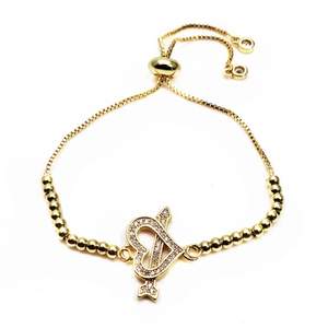 Detail of adjustable gold heart bracelet with Cupid's arrow and pavé zircon stones