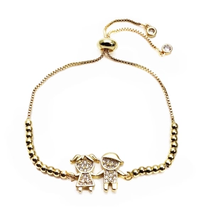 Detail of gold adjustable box chain bracelet with micro-pave boy and girl charms