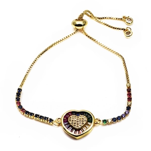 Detail of adjustable gold bracelet with micro-pave rainbow crystals and heart charm