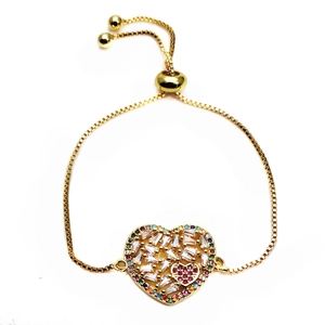 Detailed top view of gold heart bracelet with baguette zircons and adjustable slider