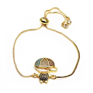 Detail of adjustable gold box chain bracelet with micro-pave boy pendant and zircon drops