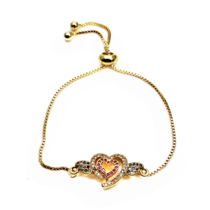 Detail of gold adjustable box chain bracelet with colorful zircon heart and wings