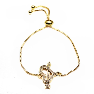 Detail of adjustable gold heart arrow bracelet with sparkling micro-pave cubic zirconia