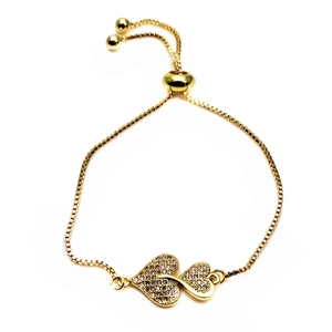 Detailed close-up of golden bolo bracelet with interlocking micro-pave zircon hearts
