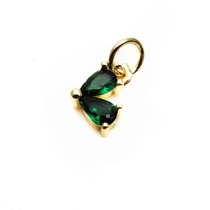 Detail of 14K gold plated heart charm with green pear-cut cubic zirconia in prong setting