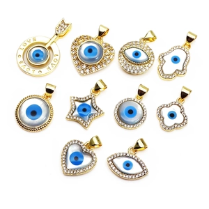 Golden Evil Eye charms collection with micro-pave zircons and colorful shell inlay