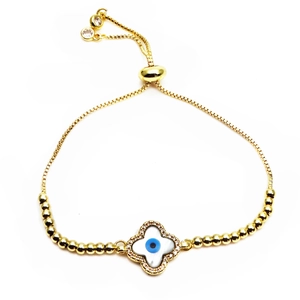 Detailed shot of gold evil eye bracelet featuring shell inlay and adjustable slider clasp