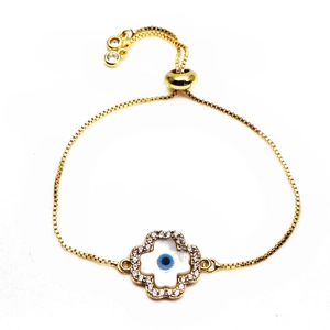 Close-up of gold box chain bracelet with adjustable slide clasp and evil eye flower charm