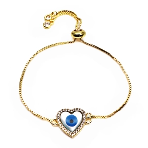 Detail of adjustable gold heart bracelet with micro-pave zircons and evil eye charm