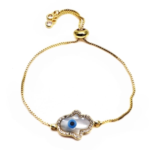 Detail of adjustable gold Hamsa Hand bracelet with blue Evil Eye and micro-set zircons