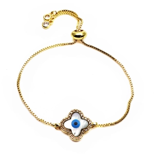 Macro view of adjustable gold clover bracelet with devil eye charm and zircon details