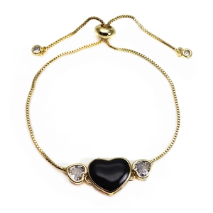 Detail of adjustable gold bolo bracelet with black heart and micro-pave zircon charms