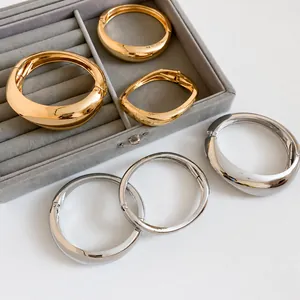 High-quality chunky geometric irregular metal bangles in polished gold and silver finishes